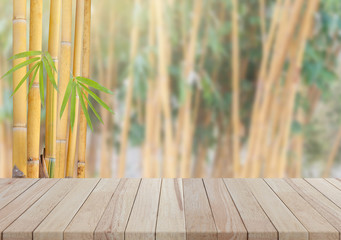 Empty wooden table with yellow bamboo tree background