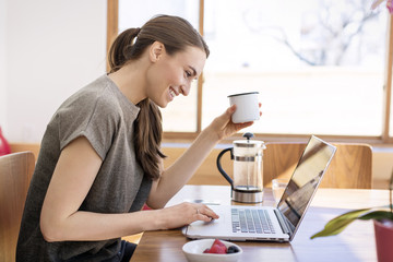 Woman drinking coffee and surfing net