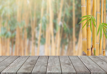 Empty old wooden table with yellow bamboo tree background