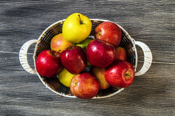 Basket in red apples, basket full of apples, apples pictures on authentic wood floor,
