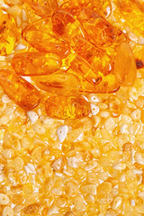 Yellow amber stones closeup lie on a flat surface.