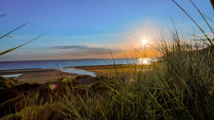 Sunset in blue sky over beach 