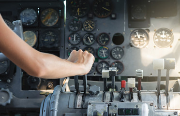 Airplane Cockpit thrust levers with female hand on top for takeoff