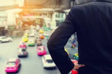 Businessman watching bad traffic on the street