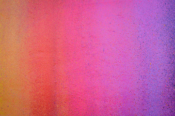 Part of a stone wall with colorful paint marks, paint texture, paint sprayed wall with colorful stains and flowing paint
