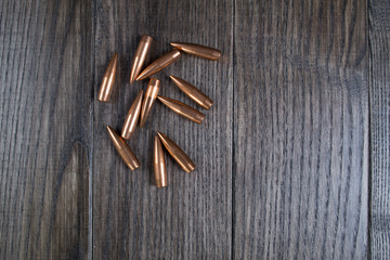 Group of   bullets on dark wooden background