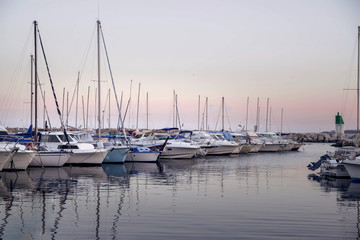 Fototapeta premium picturesque sunset with yachts at the pier on the coast