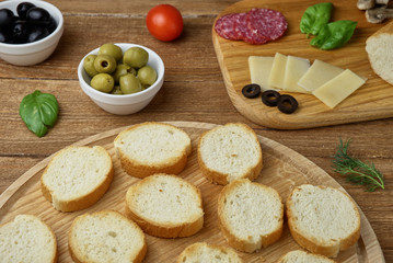 Delicious Crostini with different toppings on wooden background