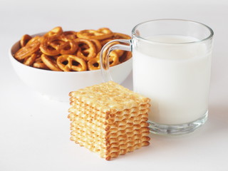 A glass of milk with cookies