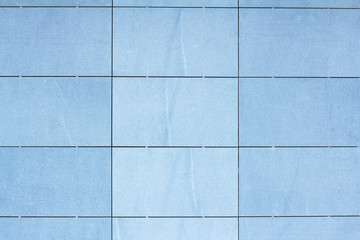 Texture of blue tile on a facade of modern building 