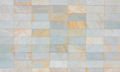 Texture of beige and gray tile on a facade of modern building