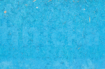 Fototapeta na wymiar Blue painted chipboard texture. Construction panel 