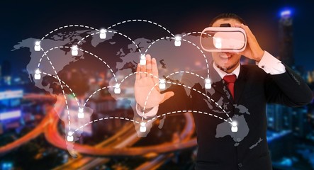 Young asian businessman wearing VR virtual reality headset, business and technology concept for future with world map social media connection on blurred night city background, color tone effect.