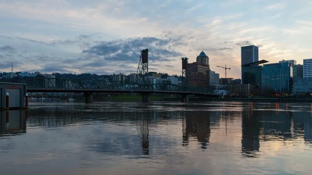 Time lapse of sunset and clouds over downtown Portland Or and Hawthorne bridge with water reflection into blue hour and night 4k uhd