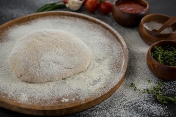 Pizza dough ball on a wooden tray