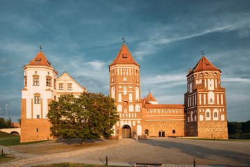Fototapeta na wymiar Mir, Belarus. Mir Castle Complex On Blue Sunny Sunset Sky Backgr
