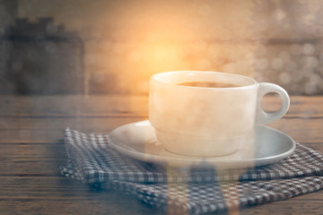 Blure of water drop on glass windows with coffee cup on wood table.