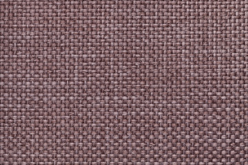 Fototapeta na wymiar Brown background with braided checkered pattern, closeup. Texture of the weaving fabric, macro.