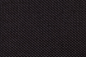 Black background with braided checkered pattern, closeup. Texture of the weaving fabric, macro.