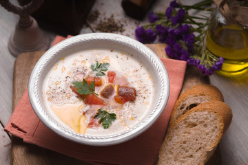 Soup puree with salmon in a ceramic bowl closeup