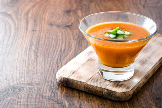 Traditional Spanish cold gazpacho soup on wooden table

