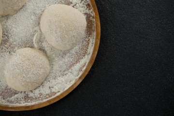 Bread dough ball on a wooden tray