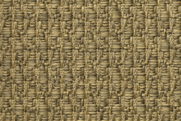 Yellow knitted woolen background with a pattern of soft, fleecy cloth. Texture of gold textile closeup.