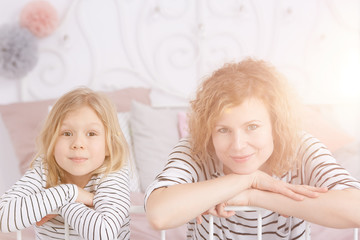 Smiling mom and daughter