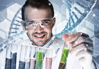 Young scientist mixing reagents in glass flask in clinical laboratory