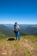 Fototapeta premium Dreaming woman, traveler with backpack relax on a top of mountain