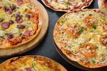 Various pizza arranged on a wooden tray