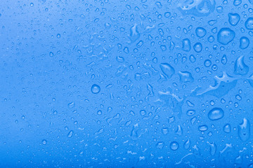 Drops of water on a color background. Blue. Selective focus. Shallow depth of field. Toned