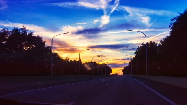 Driving on highway at spectacular summer sunset. Full HD