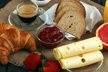 breakfast on table with waffles, croissants, coffe and juice