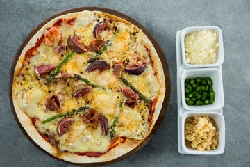 Italian pizza served with ingredients on a pizza tray