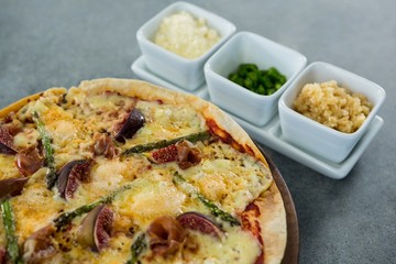 Italian pizza served with ingredients on a pizza tray