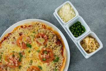 Italian pizza served with ingredients on a plate