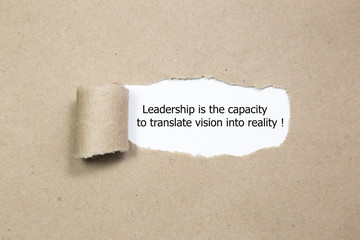 Leadership is the capacity to translate vision into reality written under torn paper