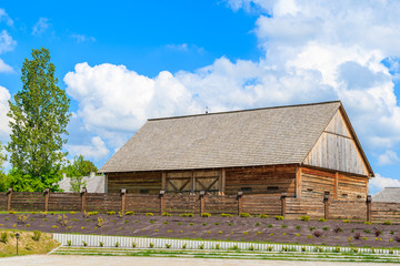 Old wooden barn in Tokarnia village on sunny spring day, Poland