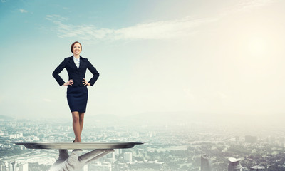 Confident elegant businesswoman presented on metal tray against cityscape background