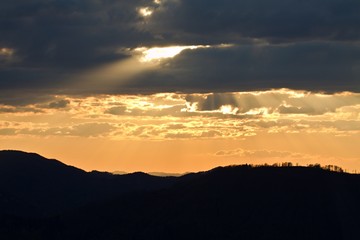 Sunrise in Slovakia. Orange sun sky over dark mountains. Romantic atmosphere. Fog hills at sunset.
