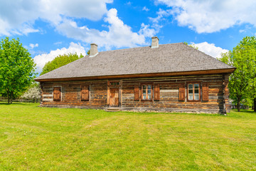 Fototapeta na wymiar Old traditional wooden house in Tokarnia village on sunny spring day, Poland