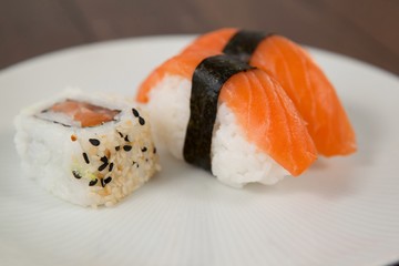 Nigiri and uramaki sushi served in white plate