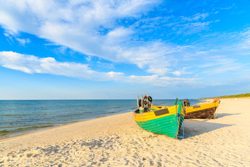 Colorful fishing boats on sandy Debki beach during sunny summer day, Baltic Sea, Poland