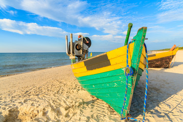 Colorful fishing boats on sandy Debki beach during sunny summer day, Baltic Sea, Poland