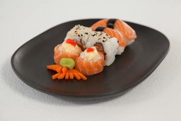 Maki, uramaki and nigiri sushi served in black plate