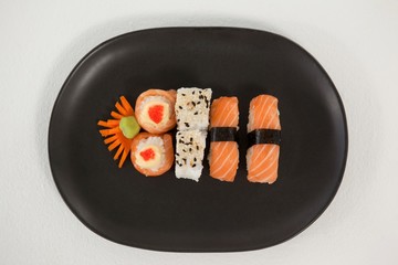 Maki, uramaki and nigiri sushi served in black plate