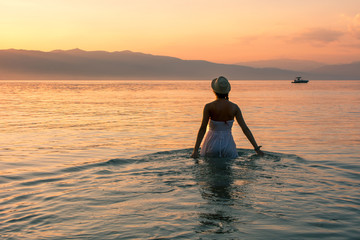 Walk towards sunset in the lake