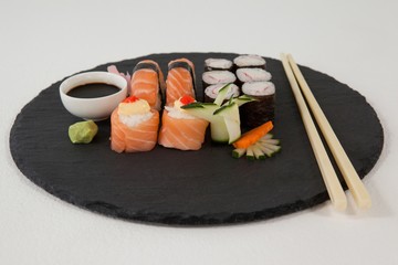 Set of assorted sushi served on black stone slate 