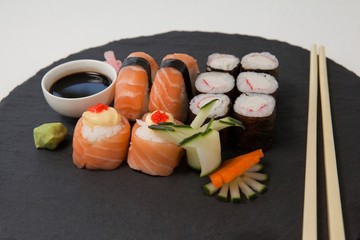 Set of assorted sushi served on black stone slate 